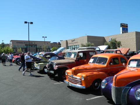 1979 Ford Bronco - Several classic cars are lined up at an outdoor car show under a clear blue sky.