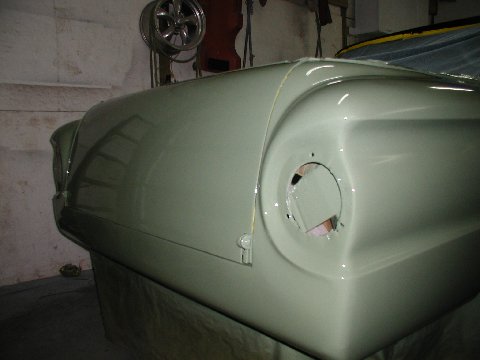 1960 Ford Ranchero - A light green car's fender and headlight housing are visible in this side-view photograph.