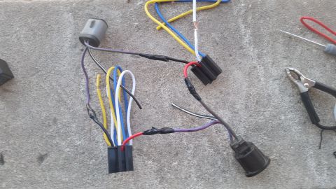 1985 Ford Bronco - A close-up view of an automotive wiring harness, showing various electrical connections and wires.