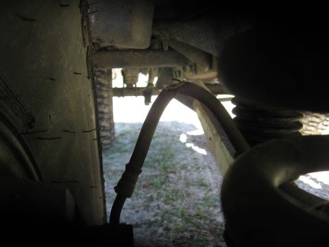 1994 Ford Bronco - A close-up view of a vehicle's undercarriage reveals a damaged brake line.