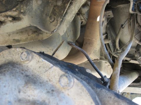 1994 Ford Bronco - Close-up of the underside of a vehicle, showing the differential and exhaust system components.
