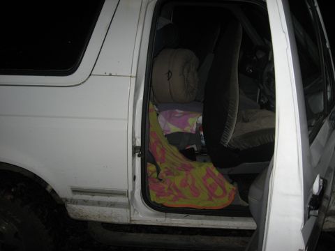 1994 Ford Bronco - Interior view of a white 1994 Ford Bronco, packed with camping gear.