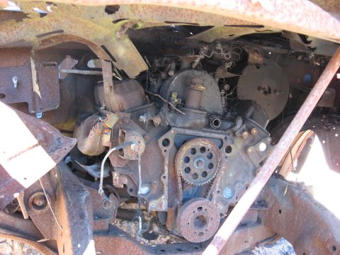1994 Ford Bronco - Close-up of a heavily corroded engine block and associated parts, showing significant rust damage.
