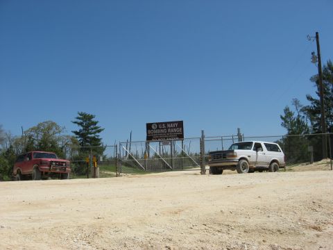 1994 Ford Bronco - Two Ford Broncos are parked outside the U.S. Navy Bombing Range on a clear day.