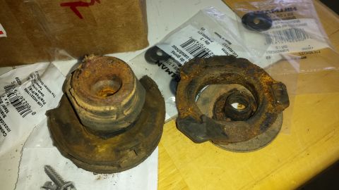 1991 Buick Reatta - These heavily corroded suspension parts are shown with their original packaging, suggesting they are replacement components.