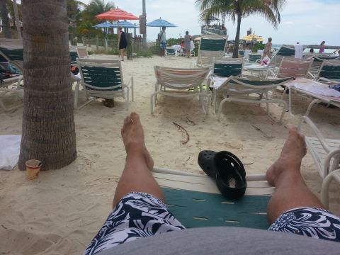 2007 Ford F-250 - Relaxing on a tropical beach with lounge chairs and umbrellas set up on the sand.