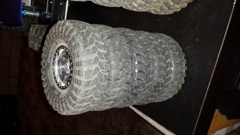 1993 Toyota 4Runner - Four aggressive tread off-road tires with custom rims are displayed.