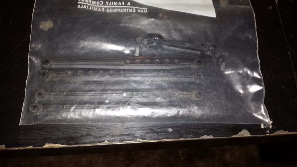 Parts in a plastic bag with text visible