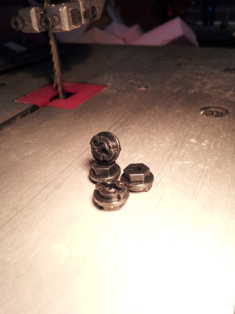 1995 Ford Bronco - Lug nuts are shown on a workbench next to a bandsaw blade.