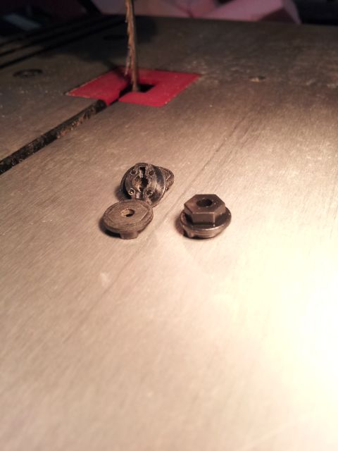 1995 Ford Bronco - Fasteners sit on a workbench next to a bandsaw blade, ready for use.