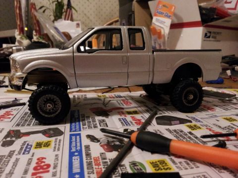 1995 Ford Bronco - Model truck assembly in progress, with tools and glue visible on the workbench.