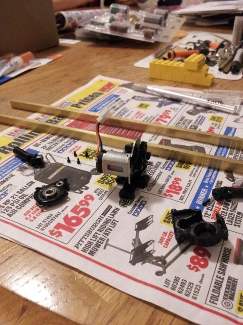 1995 Ford Bronco - Various components and tools are spread across a table, suggesting a project in progress.