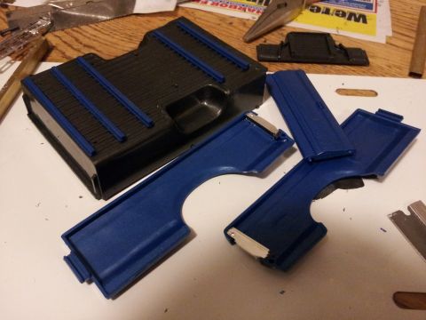 1995 Ford Bronco - Model car parts laid out on a workbench with tools and a Supermotors.net logo visible.
