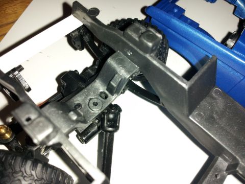 1995 Ford Bronco - Close-up of model car parts, including chassis and blue body. Supermotors.net logo is present.