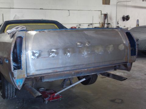 1973 Ford Ranchero - Rear of a 1973 Ford Ranchero in a shop, being prepped for paint with bodywork visible.