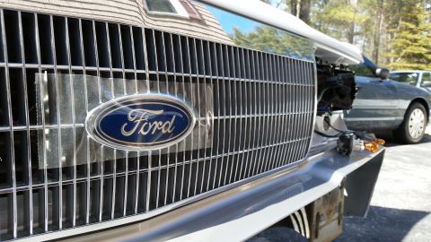 1991 Ford LTD Crown Victoria - Close-up of the chrome grille and Ford emblem on a 1991 Ford Crown Victoria LTD, with another vehicle visible in the background.