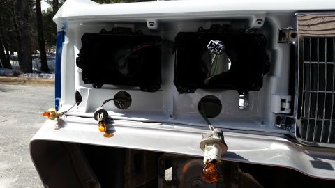 1991 Ford LTD Crown Victoria - Front view of a 1991 Ford Crown Victoria LTD with headlight assemblies removed for repair or modification.