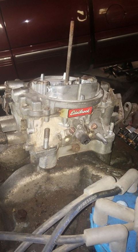 1979 Ford Bronco - Close-up of an Edelbrock carburetor, part of engine work, with visible spark plug wires and a red branding label.