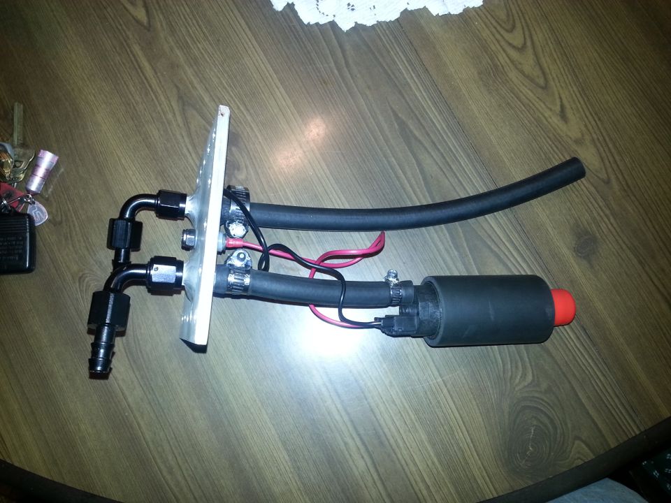Fuel pump assembly with braided lines and fittings mounted on a metal plate