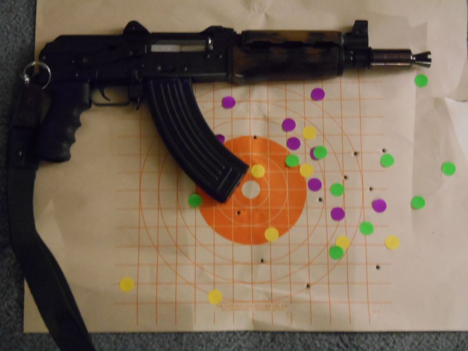 AK-47 style rifle with colorful target stickers