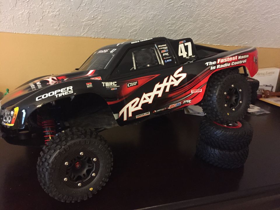 Black Traxxas radio-controlled monster truck with red accents and Cooper Tires branding