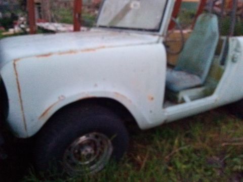 1991 Ford Bronco - This white SUV shows signs of rust and wear, with a light blue seat visible inside.