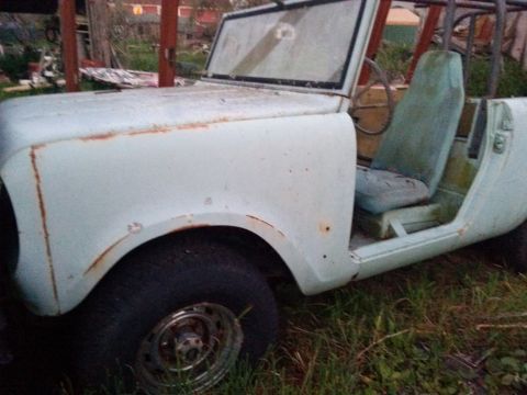 1991 Ford Bronco - This weathered vehicle sits outdoors, showing signs of age and disuse with visible rust and faded paint.
