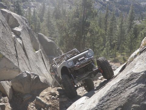 1961 International Scout 800 - Custom off-road vehicle navigates a challenging rocky terrain.