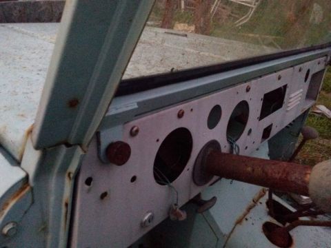 1991 Ford Bronco - The interior of a weathered vehicle shows a dashboard with empty gauge housings and a prominent rusty steering column.