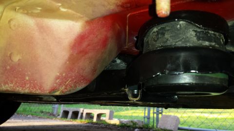 1991 Buick Reatta - Close-up of a car's undercarriage, focusing on the engine mount and frame structure.