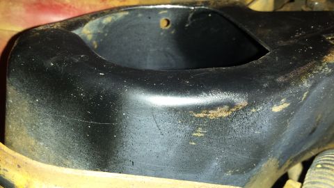 1991 Buick Reatta - Close-up of a black metal engine cradle part, showing wear and some surrounding paint.