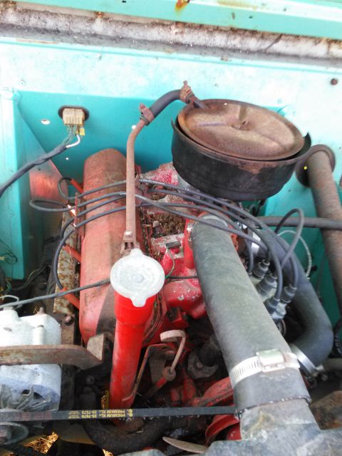 1991 Ford Bronco - View of an engine bay, showing the engine block, air cleaner, and various hoses and wires.