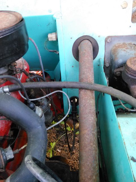 1991 Ford Bronco - Close-up view of an engine bay, focusing on an exhaust pipe and surrounding components.