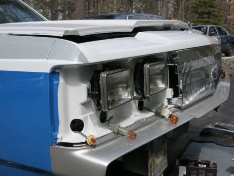 1991 Ford LTD Crown Victoria - Car's front end is partially disassembled, revealing headlights and grille components.