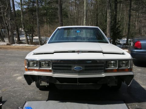 1991 Ford LTD Crown Victoria - Front view of a white 1991 Ford Crown Victoria LTD with its hood open, parked outdoors.
