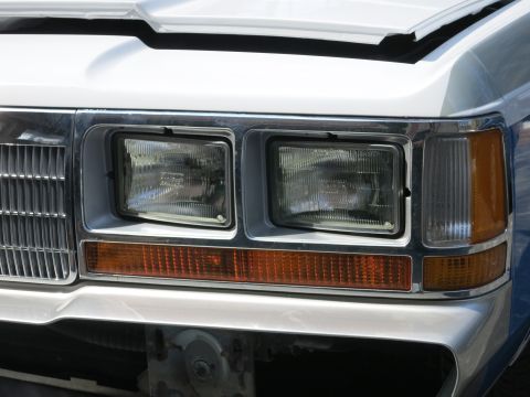 1991 Ford LTD Crown Victoria - Close-up of the front end of a 1991 Ford Crown Victoria LTD, showing the headlights and grille.