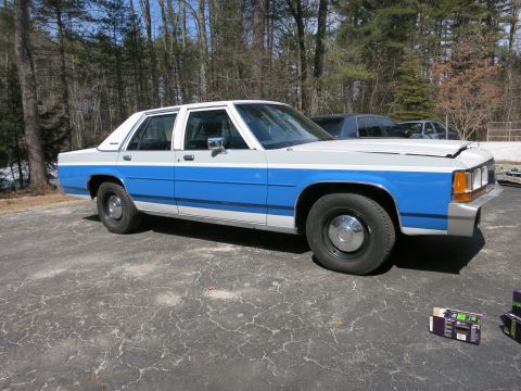 1991 Ford LTD Crown Victoria - This 1991 Ford Crown Victoria LTD is shown in a three-quarter front view, a distinctive blue and white paint scheme.