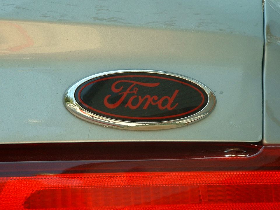 Custom black-and-red Ford oval emblem on silver panel above red taillight