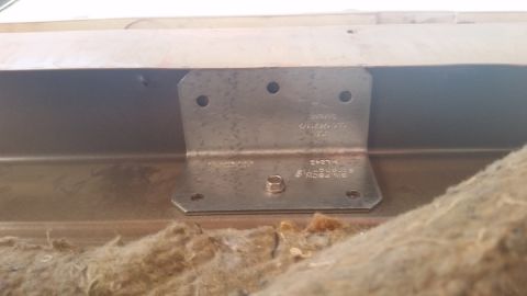 1985 Ford Bronco - A metal bracket is visible inside a vehicle, attached to an interior panel.