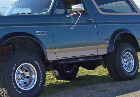 1990 Ford Bronco - Side view of a 1990 Ford Bronco, showing its body lines and BFGoodrich All-Terrain tires.