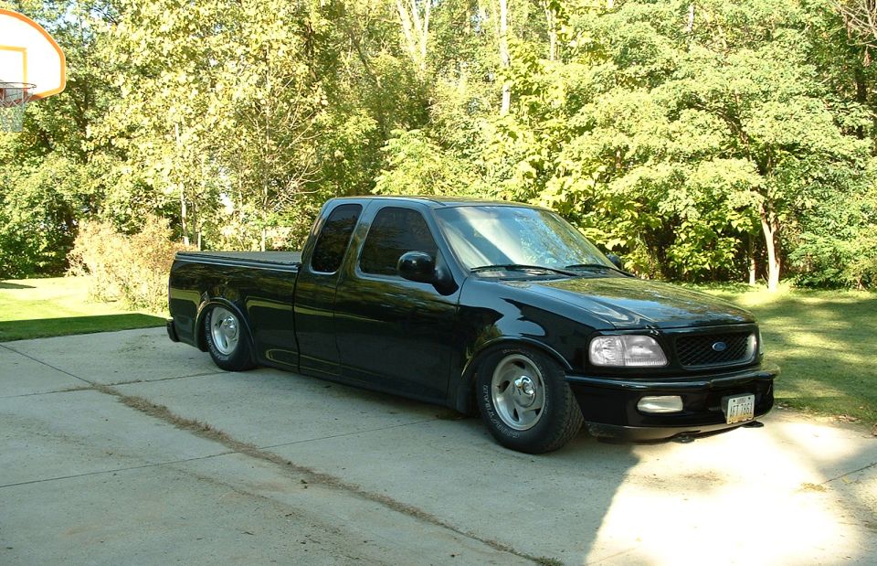 my dads truck, lowered, shaved handles, shaved emblems, removed the 4x4 sticker, clear lenses, tinted windows, removed the running boards, killed the chrome, removed side moldings