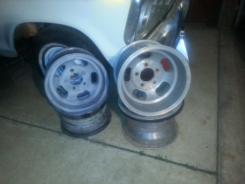 1973 Ford F-100 - Aftermarket wheels are shown stacked, with part of a vehicle in the background.