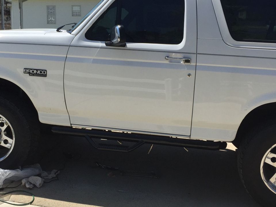 White 1995 Ford Bronco side view with running boards
