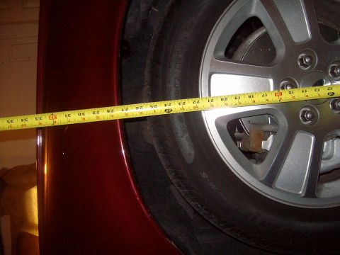 2004 Ford Crown Victoria - Measuring the wheel well clearance on a vehicle.