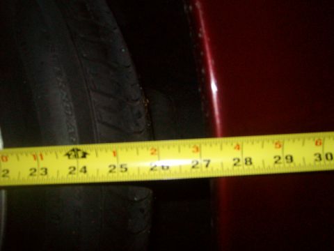 2004 Ford Crown Victoria - Measuring the clearance between the tire and the car's body panel.