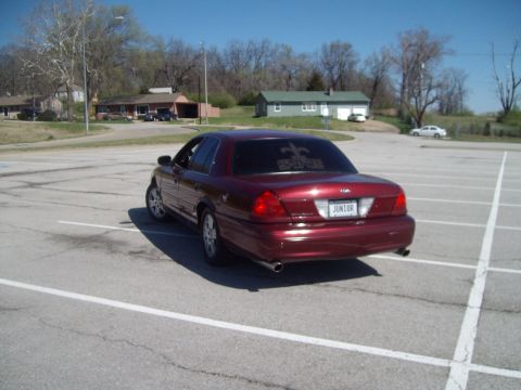 2004 Ford Crown Victoria - This 2004 Ford Crown Victoria is shown from the rear in a parking lot, a custom license plate and tinted rear window decal.