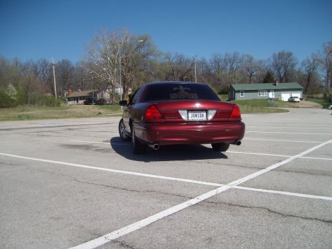 2004 Ford Crown Victoria - Rear view of a red 2004 Ford Crown Victoria with a custom license plate.