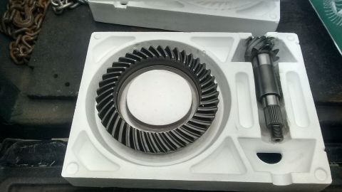 Ring and pinion gears in white foam packaging. Chain in background