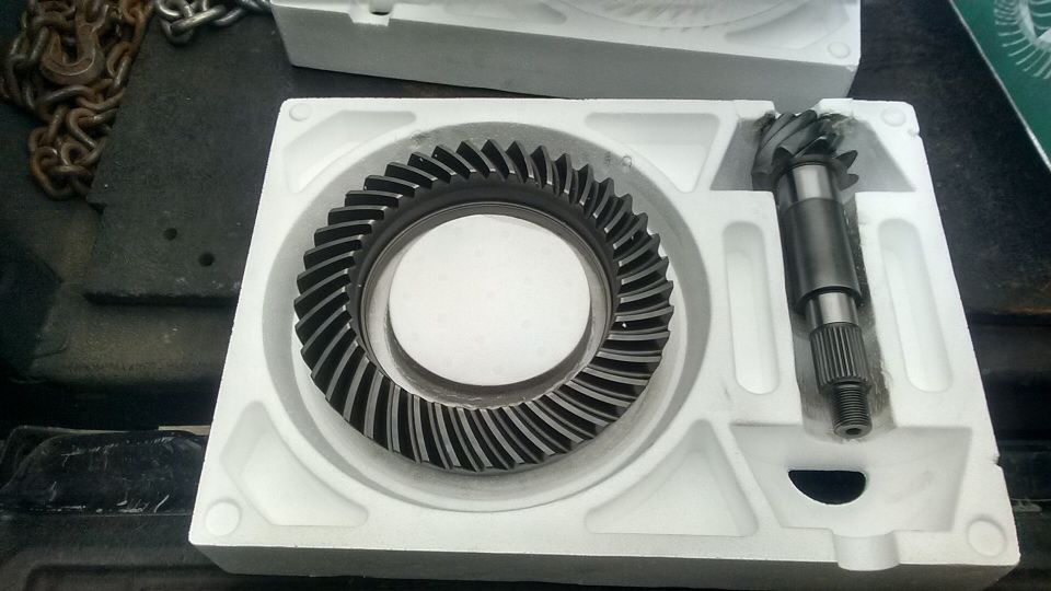 Ring and pinion gears in white foam packaging. Chain in background