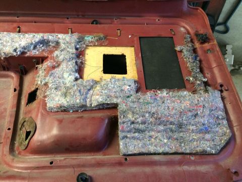 1986 Ford Bronco - Interior door panel removed, revealing the internal structure and insulation material.